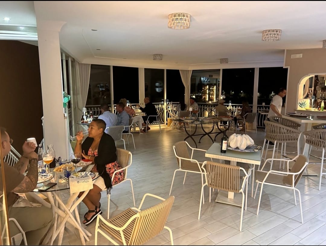 Guests dining in the bright dining room in the evening