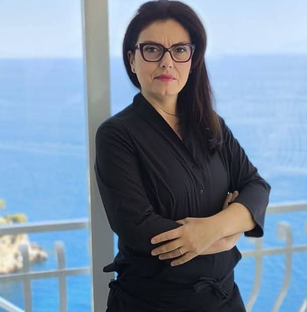 Chef Serena on the terrace of Baglio Amalfi, with the sea behind her